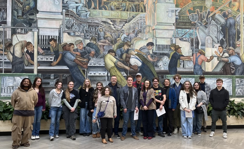 KVCC students stand before a mural by Diego Rivera.