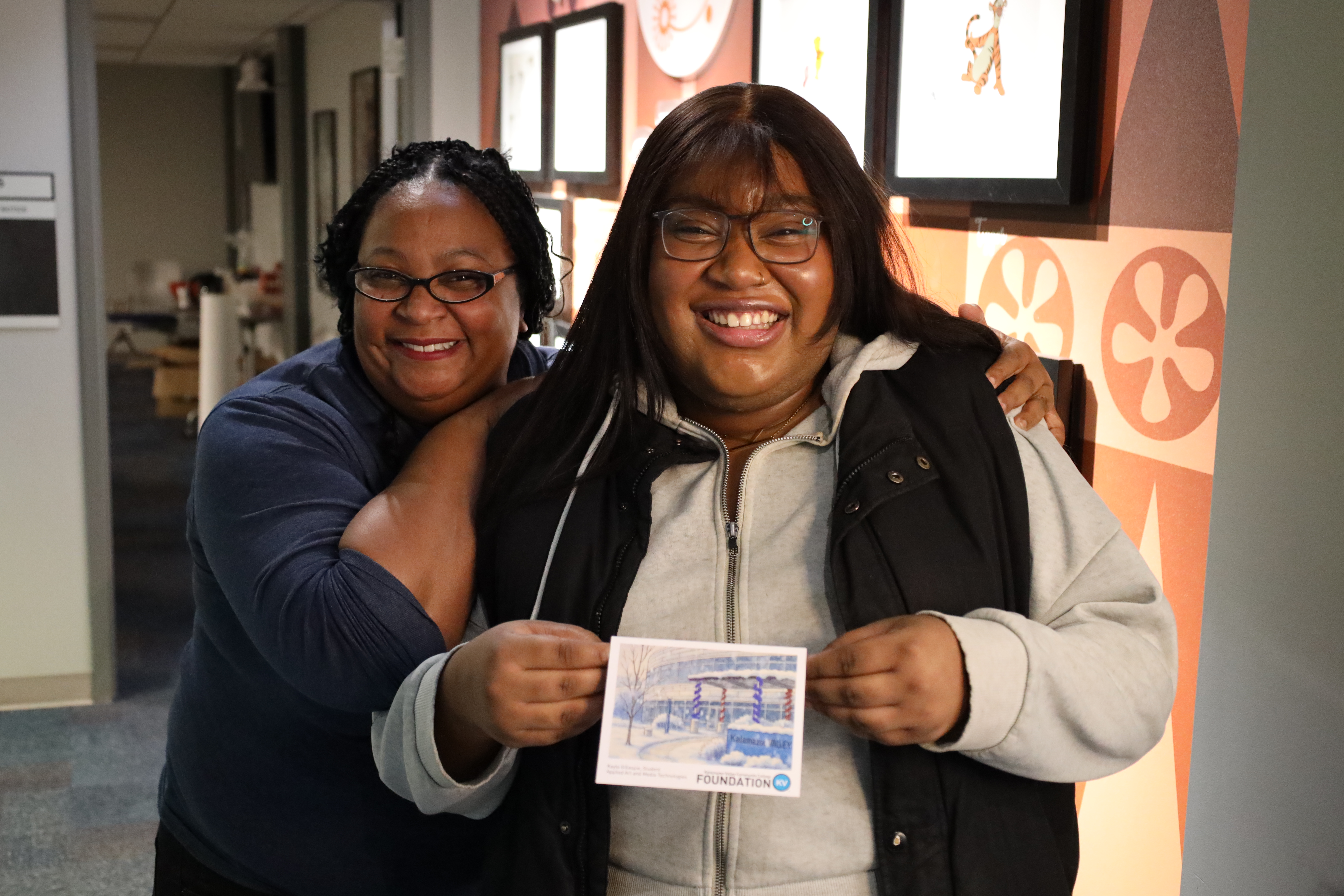 Kayla Gillespie (front) holds the card she designed with Aubrey Rogers (back).