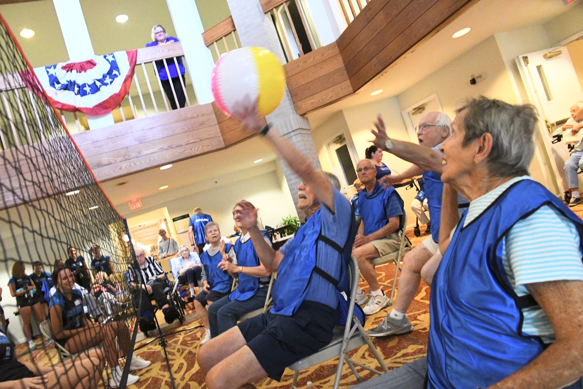 Valley volleyball team and older adults play chair volleyball at StoryPoint Kalamazoo at Bronson Place.